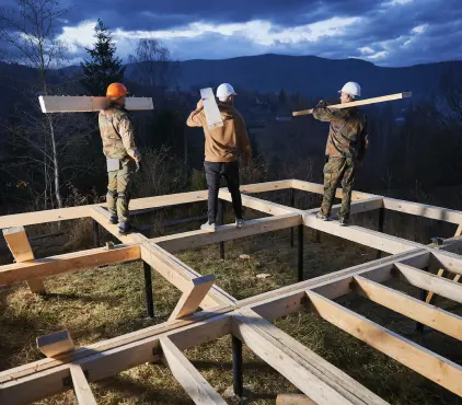 construction team builds wooden deck